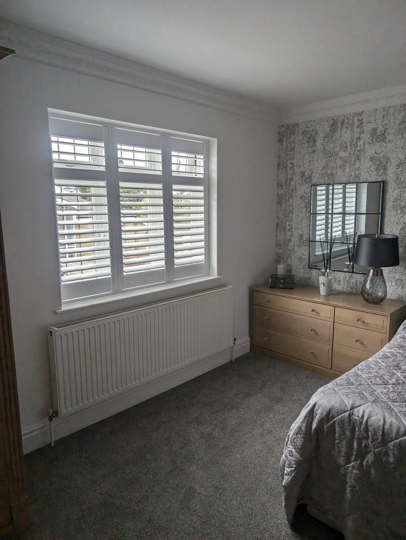 white window shutter in a bedroom