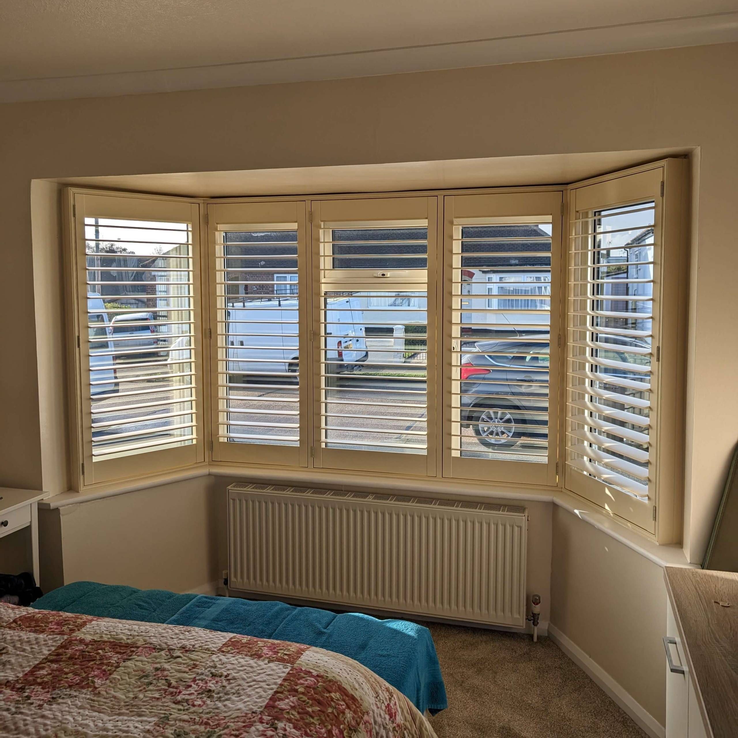 shutters on a bay window cream shutters